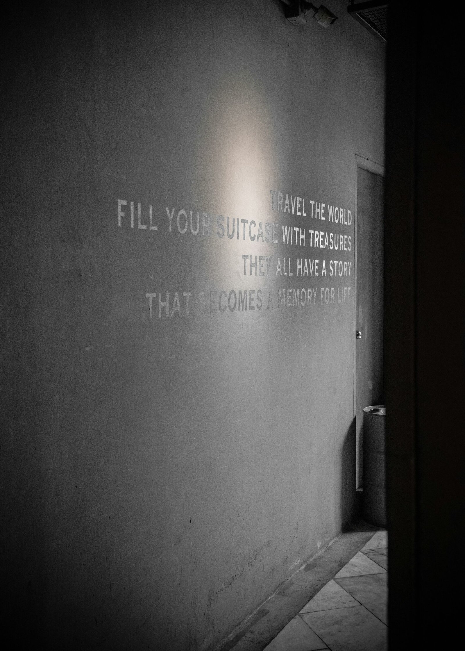 a black and white photo of a wall with writing on it